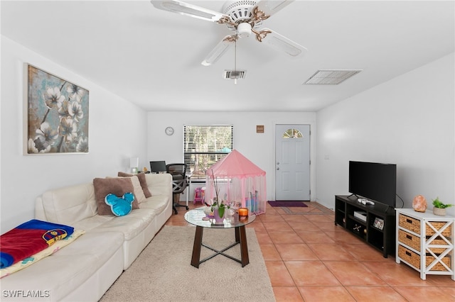living area featuring ceiling fan and light tile patterned floors