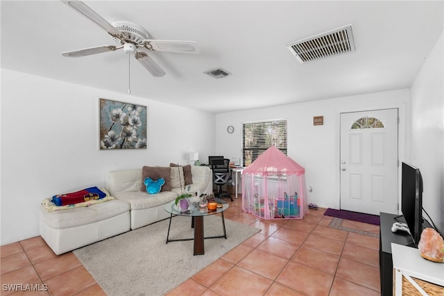 tiled living room with ceiling fan