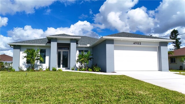 view of front of property featuring a garage and a front lawn