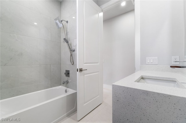 bathroom featuring vanity, tile patterned floors, and tiled shower / bath