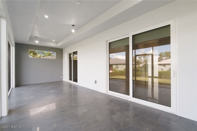 unfurnished room with a textured ceiling and a tray ceiling