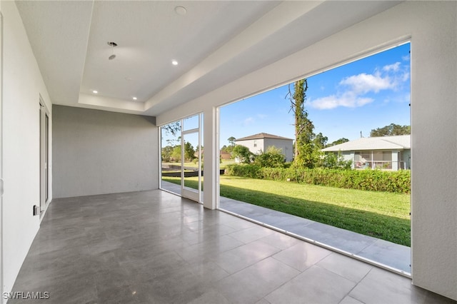 unfurnished sunroom with a tray ceiling