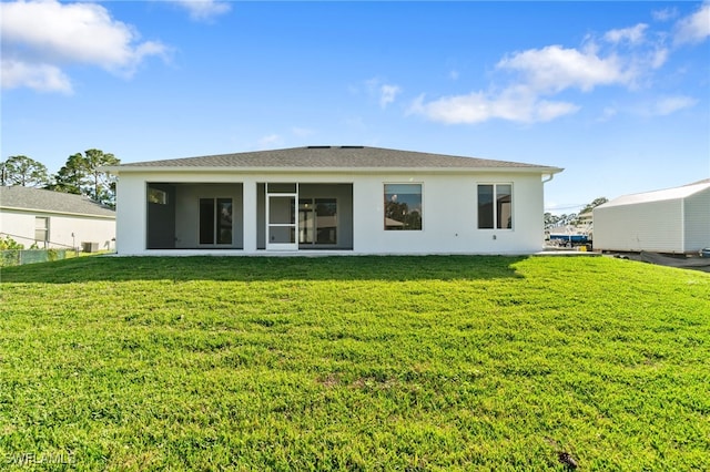 rear view of house with a yard