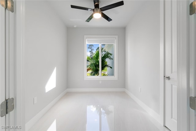 empty room featuring ceiling fan and light tile patterned flooring