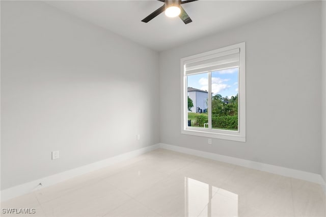 tiled empty room with ceiling fan