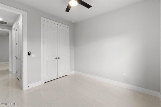 unfurnished bedroom featuring a closet and ceiling fan