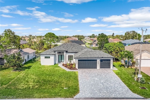 view of front of house with a front yard and a garage