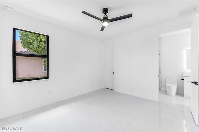 unfurnished room with light tile patterned floors and ceiling fan