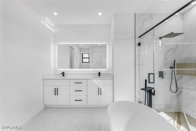 bathroom with double vanity, a soaking tub, a marble finish shower, and a sink