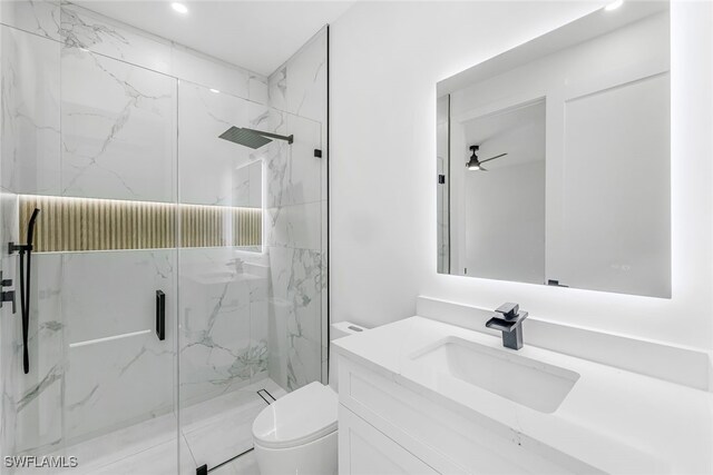 bathroom with toilet, ceiling fan, a marble finish shower, and vanity