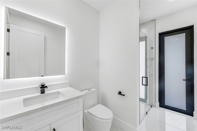 bathroom featuring tile patterned flooring, vanity, and toilet