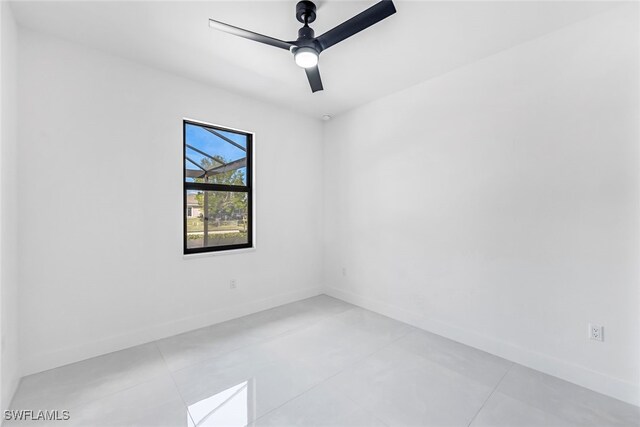 empty room featuring ceiling fan and light tile patterned flooring