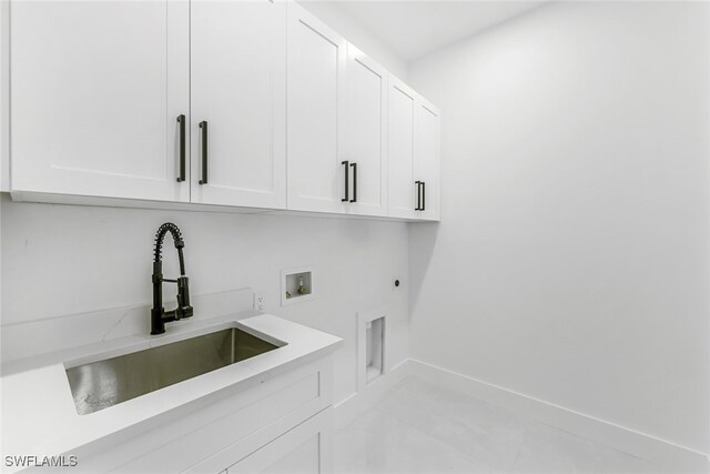 laundry room featuring washer hookup, sink, cabinets, and hookup for an electric dryer