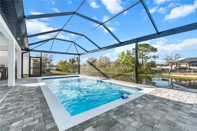 pool featuring a patio, a water view, and a lanai