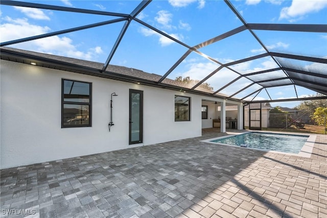 pool featuring a lanai and a patio area