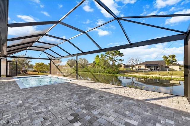 pool with a patio area, a lanai, and a water view