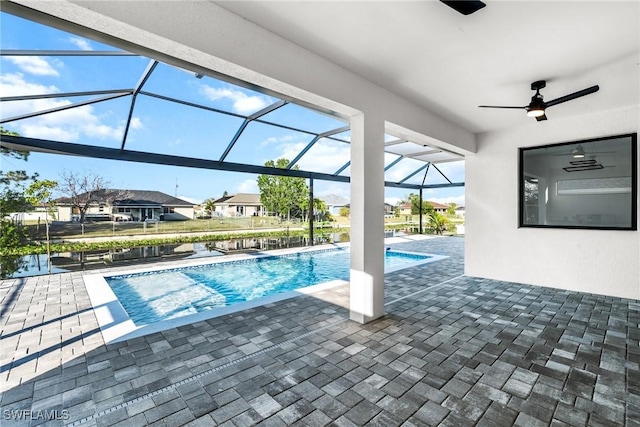 pool with a patio, a residential view, a lanai, and a ceiling fan