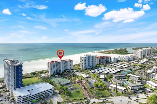 bird's eye view with a water view and a beach view