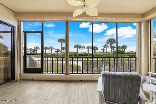 sunroom featuring ceiling fan