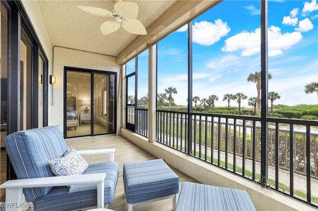 sunroom featuring ceiling fan