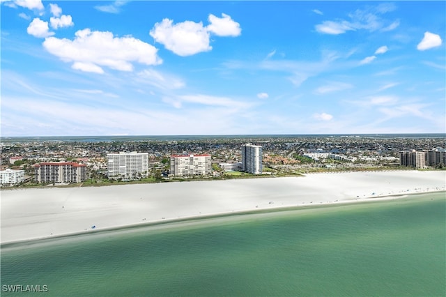 aerial view with a water view and a beach view