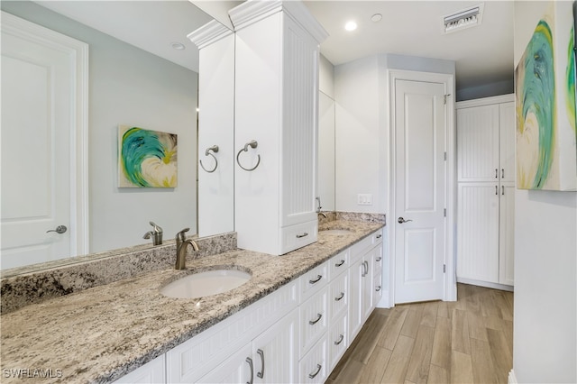 bathroom featuring vanity and hardwood / wood-style floors