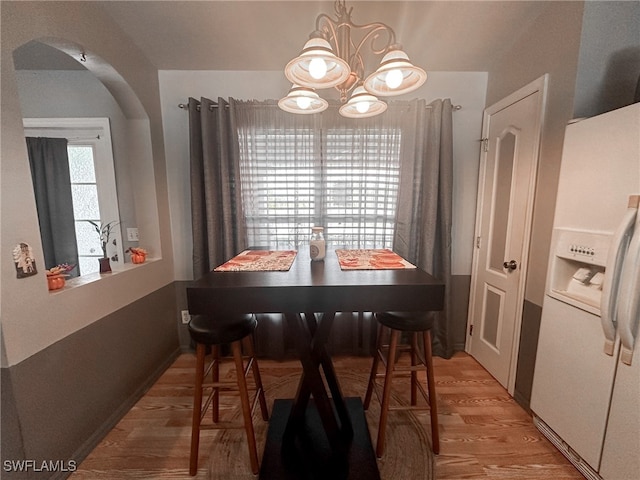 dining area featuring a chandelier and light hardwood / wood-style flooring