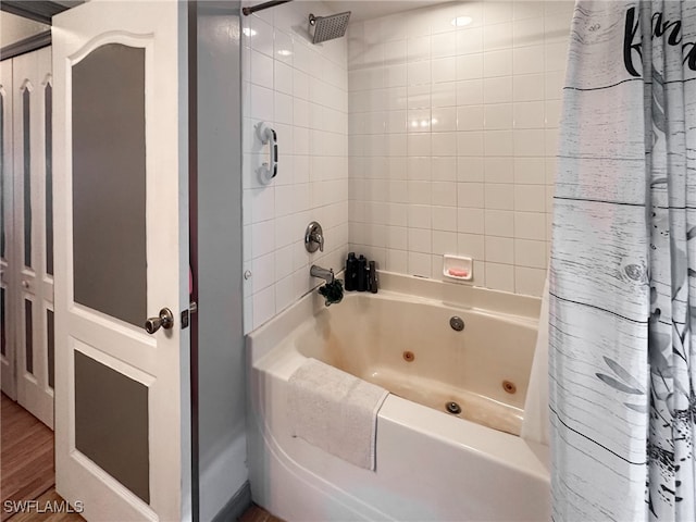 bathroom featuring wood-type flooring and shower / bath combo