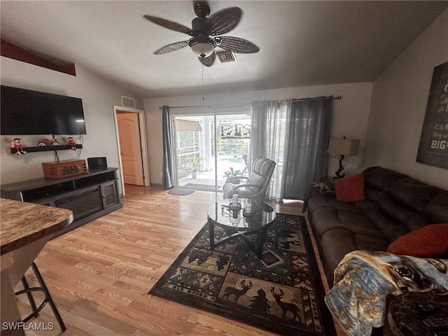 living room with light wood-type flooring, lofted ceiling, and ceiling fan