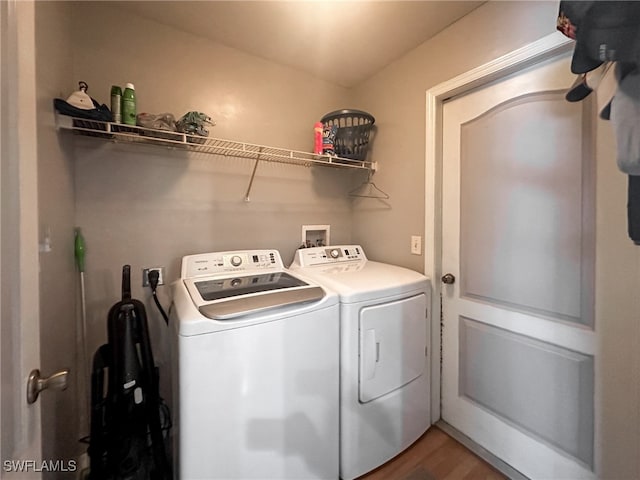 laundry area with hardwood / wood-style floors and independent washer and dryer