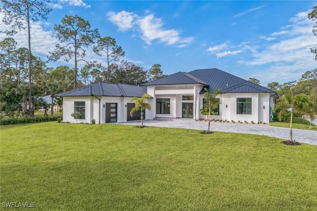 1125 Oakes Blvd, Naples, FL 34119 - rear view of property with a standing seam roof, a lawn, metal roof, and stucco siding