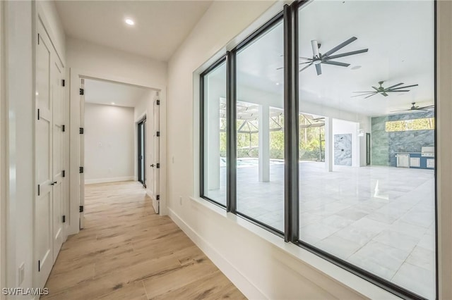 hallway with light hardwood / wood-style flooring