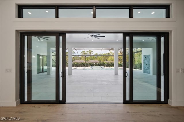 doorway to outside featuring ceiling fan