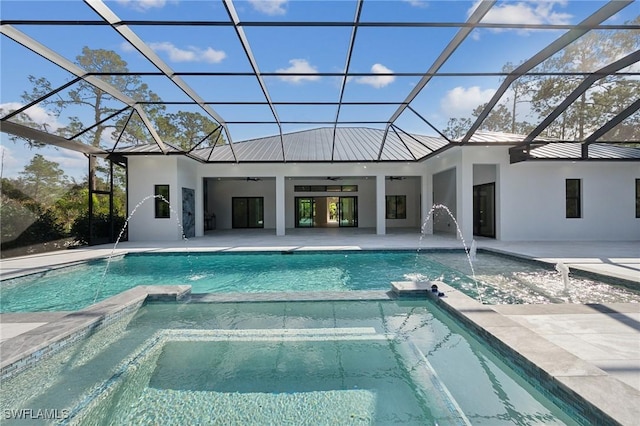 view of swimming pool with a patio, a lanai, pool water feature, and ceiling fan