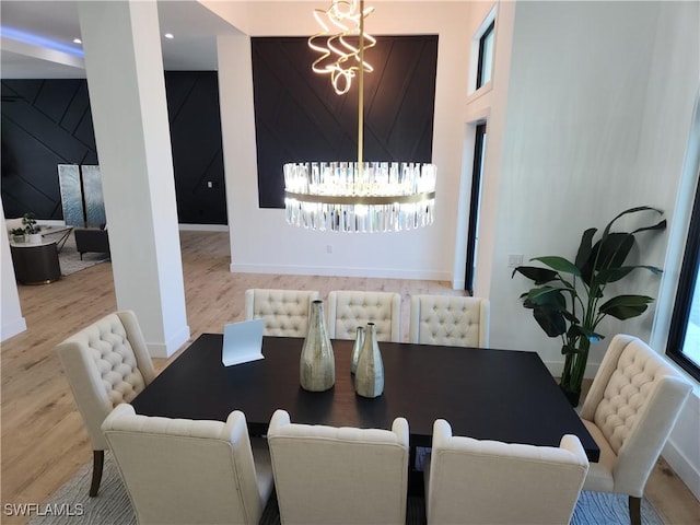 dining space with an inviting chandelier and hardwood / wood-style flooring