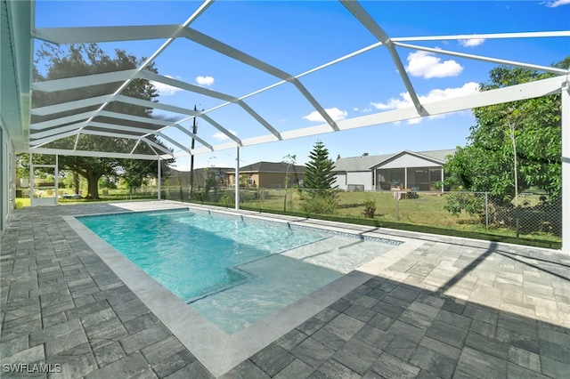 view of pool with a patio area and a lanai