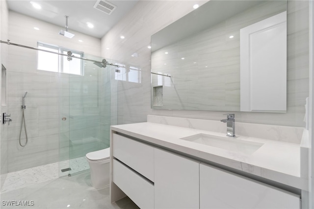 bathroom featuring vanity, toilet, and an enclosed shower