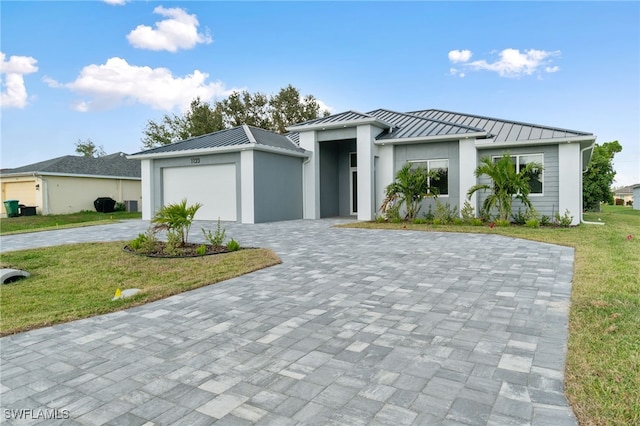 view of front of house featuring a garage and a front lawn