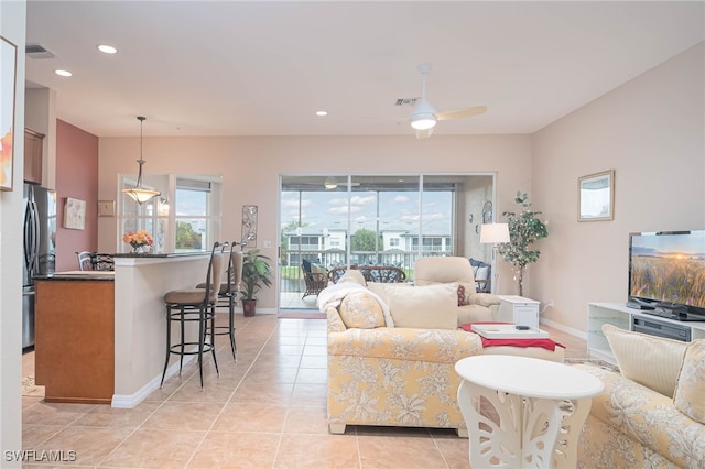 living room with light tile patterned flooring and ceiling fan