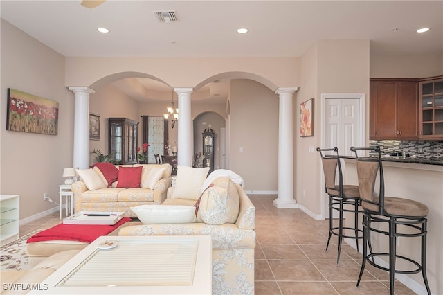 tiled living room featuring ornate columns