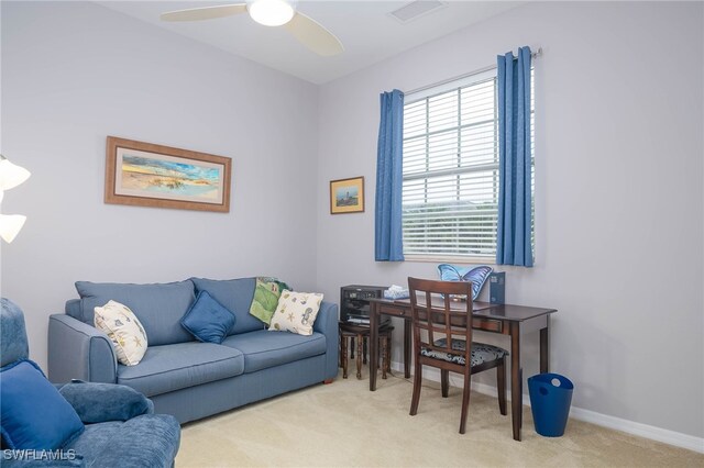 office space with light colored carpet and ceiling fan