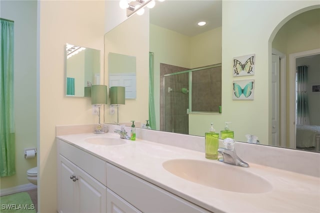 bathroom with vanity, toilet, and an enclosed shower