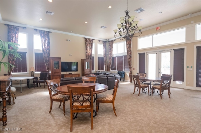 dining room with french doors, a chandelier, ornamental molding, light colored carpet, and a high ceiling