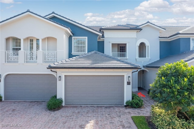 view of front of home featuring a garage and a balcony