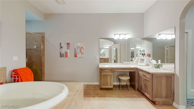 bathroom with tile patterned flooring, plus walk in shower, and vanity