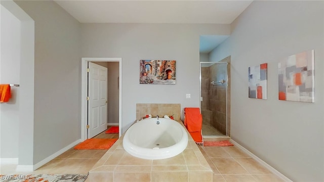 bathroom featuring tile patterned floors and independent shower and bath