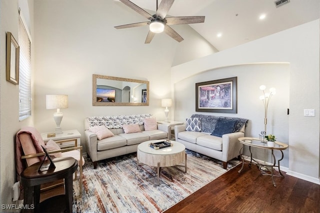 living room with ceiling fan, hardwood / wood-style floors, and high vaulted ceiling