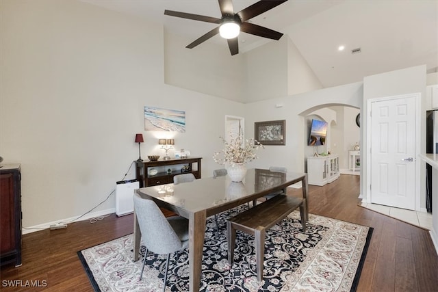 dining area featuring ceiling fan, dark hardwood / wood-style flooring, and high vaulted ceiling