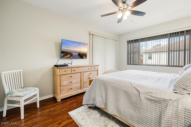 bedroom with ceiling fan and dark wood-type flooring