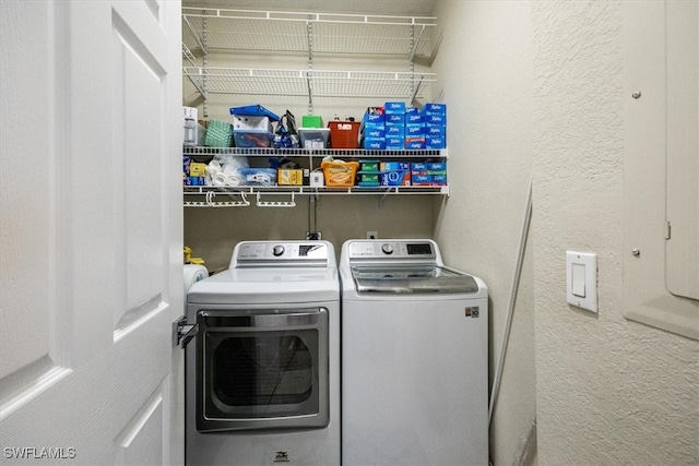 washroom featuring washer and clothes dryer